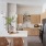 Savannah, GA, Pet-Friendly Luxury Apartments - Aventon Victory - Spacious Kitchen with Herringbone Tile Backsplash, Kitchen Island with Accent Pendant Lighting, Stainless Steel Appliances, Beige Elm Cabinets with White Quartz Countertops, and Wood-Inspire